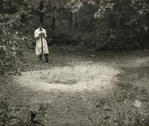 Teen Ufologist David J. Halperin in his raincoat photographs a hole in the ground in Glassboro NJ in 1964.